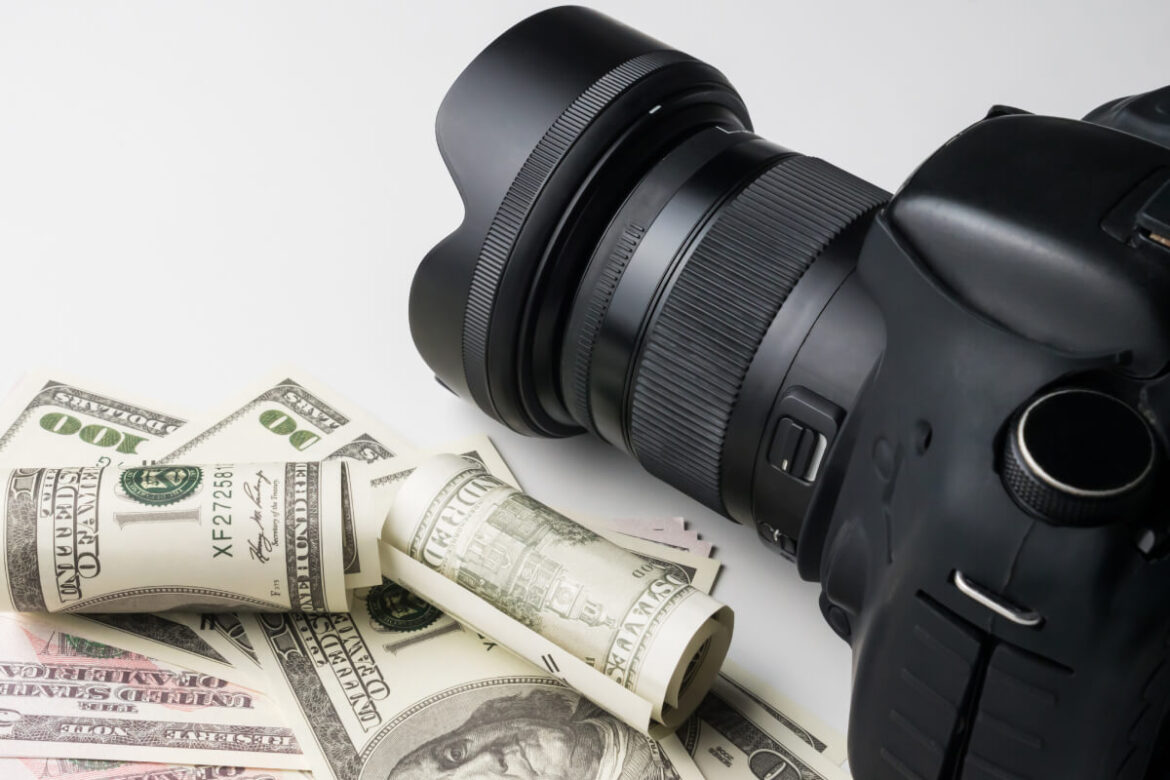 a-black-digital-camera-on-banknotes-with-white-bac-2022-12-16-03-08-44-utc (1) (1) real estate photography cost