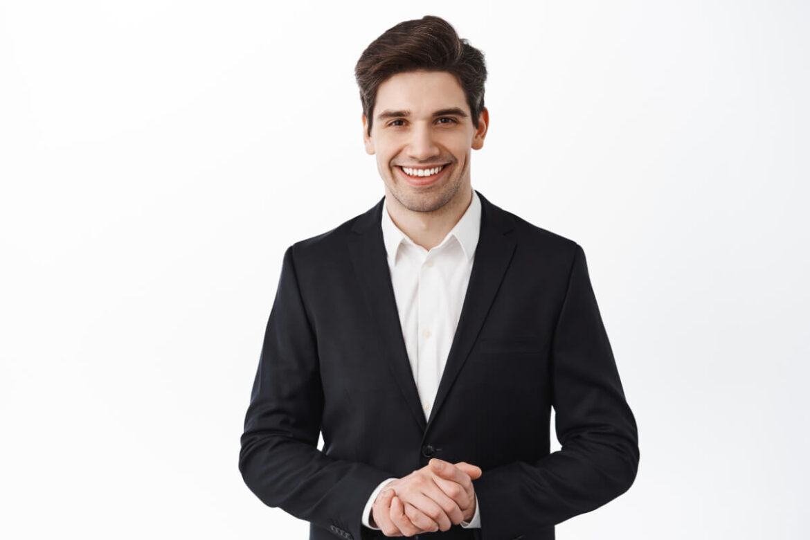 handsome-corporate-man-real-estate-agent-assistant-smiling-hold-hands-together-how-may-i-help-you-smiling-friendly-polite-assist-customer-white-background (1) (1) Realtor Photoshoot