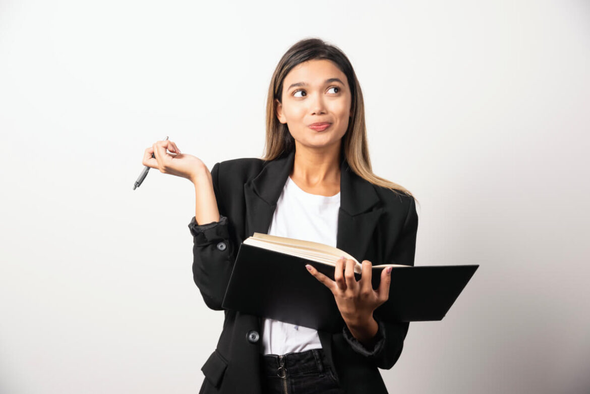 young-businesswoman-writing-clipboard-with-pencil (1) (1) real estate photography pre-shoot checklist